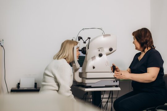 Ophthalmologist conducting vision check with autorefractor machine