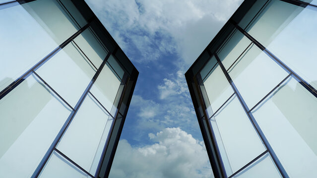 Architectural Detail of Glass Building Against Bright Sky