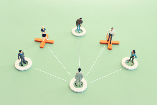 miniature figure forming teamwork. Concept of leadership, business, and challenge