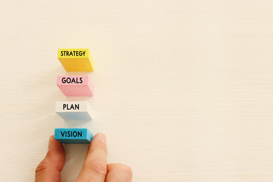 Wooden colorful cubes and the word strategy on white background