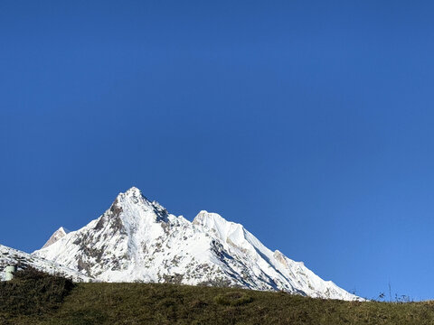 Snow covered Nanda Devi mountains above an alpine ridge in Uttarakhand