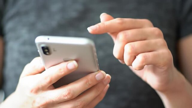Clean, well-groomed hands in muted shirt hold sleek, unbranded smartphone with blank screen, finger tapping. Subtle push-in, soft bokeh, natural light. Modern digital connectivity concept