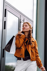 Fototapeta premium Attractive young woman with shopping bags. Consumerism, purchases, black friday, lifestyle, sale concept.
