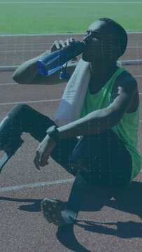 Vertical video: Teen athlete drinking bottle during training, checking watch resting blades visible