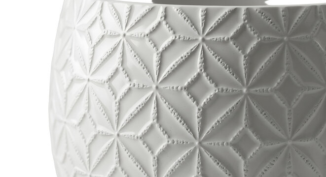 Close-up of a white ceramic vase with a geometric pattern
