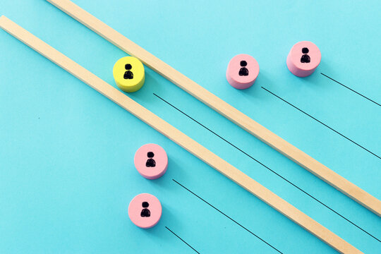 Wooden cubes with people icons over pastel background, human resources and management concept