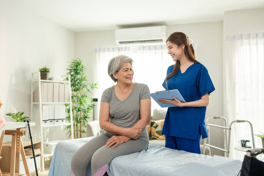 Asian beautiful caregiver examine senior woman patient at nursing home