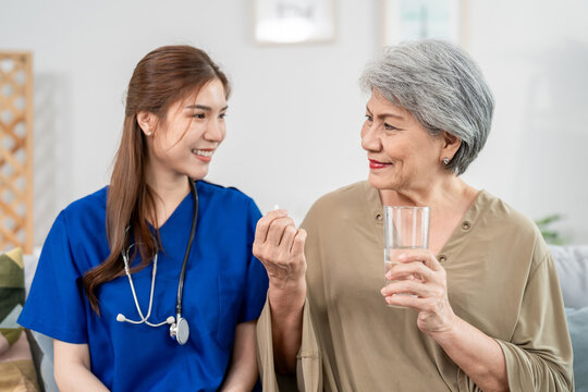 Asian caregiver give consultant to senior woman patient at nursing home. 