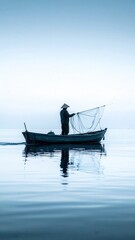 Obraz premium Fisherman in a Boat on a Calm Sea at Dawn.
