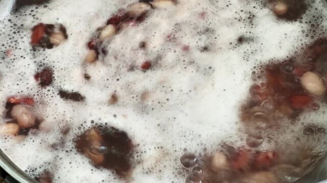 Boiling of white and red kidney beans in cooking pot