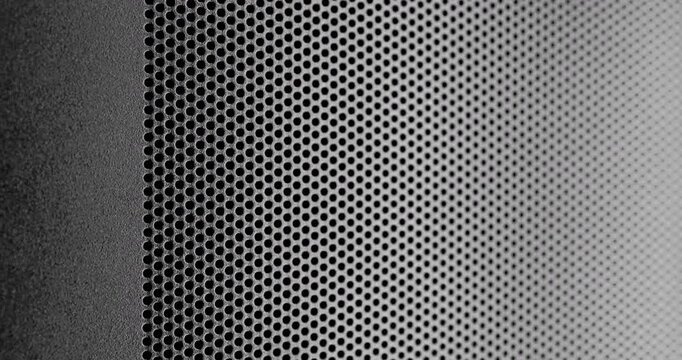 Black perforated surface texture.  Dark perforated surface with a repeating hole pattern, creating a textured and industrial look.