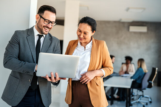 Diverse startup, business people working together on laptop computer in modern office