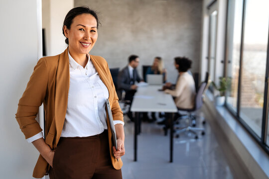 Professional in office environment, highlighting teamwork, collaboration, leadership, and innovation