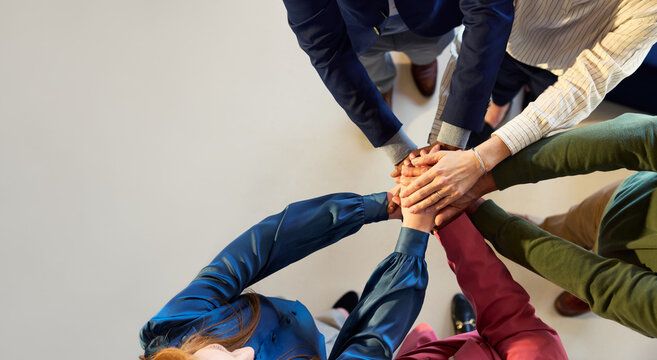 Top view of business people stacking hands