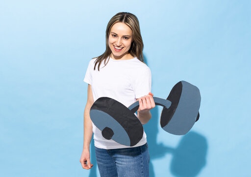 Woman holding a fake paper dumbbell showing strength and fitness