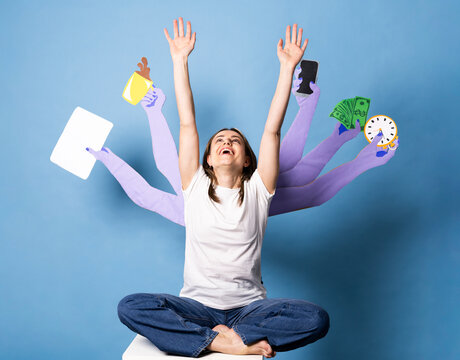 Smiling worker multitasking with paper arms on blue background