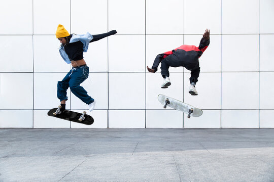 Synchronized skateboarding trick in the air at MACBA Barcelona