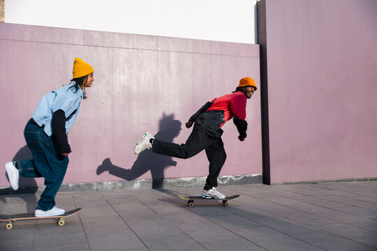 Skateboarders riding down a street in El Raval Barcelona