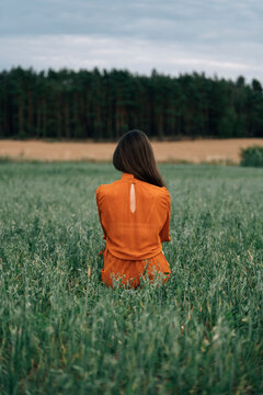 Woman standing amidst green corn crops in field
