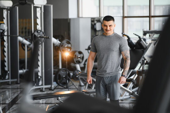 Male athlete smiling standing in modern gym