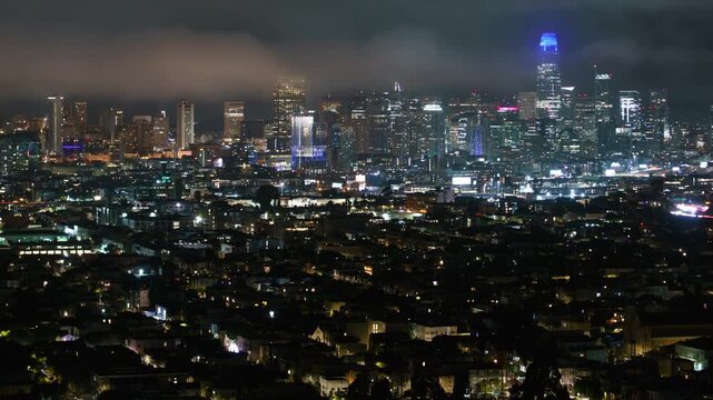 San Francisco Downtown Foggy Skyline from Bernal Heights Night Time Lapse Pan R California USA