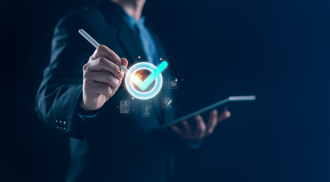 Businessman using digital tablet and stylus to confirm checklist with glowing checkmark icon, representing quality control, compliance verification, and efficient workflow in a corporate environment.