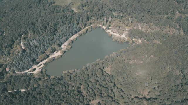 Aerial View of Karagol Lake Surrounded by Dense Green Pine Forest in Izmir Turkey. High quality 4k footage