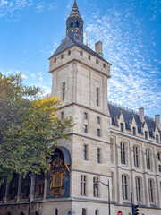 Naklejka premium Medieval corner of the Conciergerie with the famous Tour de l'Horloge clock tower in Paris, France