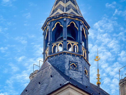 A close-up architectural shot of the top of the Tour de l'Horloge (Clock Tower) of the Conciergerie in Paris, France