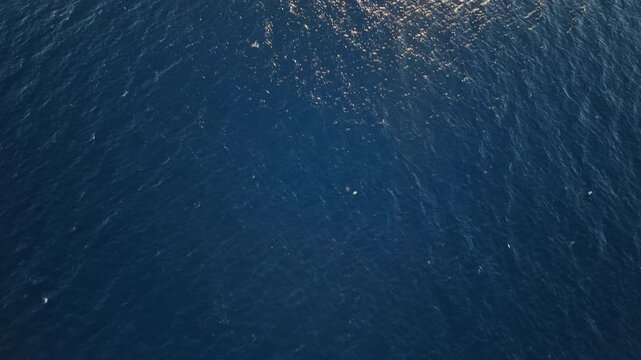 Aerial view of deep blue Mediterranean sea surface near Calpe Spain transition shot