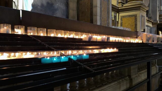 Serene scene of devotion illuminated by gentle candle glow
