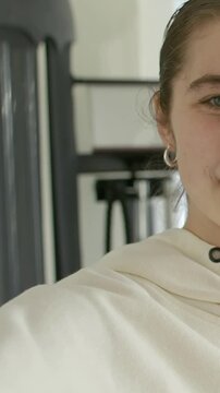 Vertical video: Woman moving in, speaking, gesturing, pointing at cable and mic coaching fitness