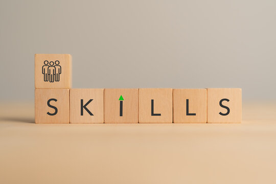 Skills Development and Human Capital Growth Concept. Wooden blocks spelling SKILLS with a people icon. Workforce capability, talent development and continuous learning for organizational growth.
