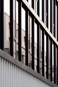 Modern architecture facade with glass windows shows office corporate finance pattern and symmetry across diagonal lines creating minimal copyspace