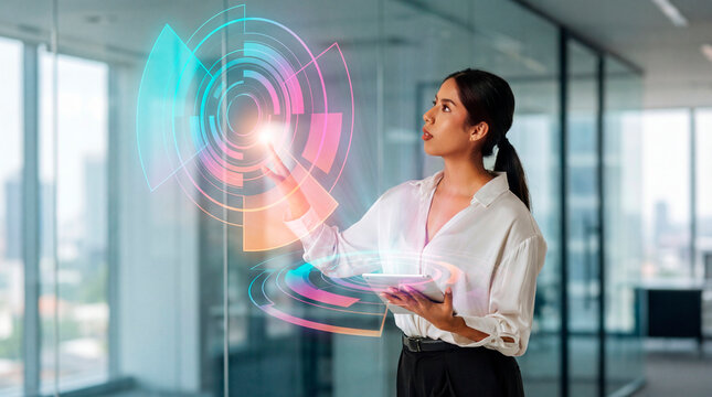 Business woman interacting with circular holographic interface on tablet