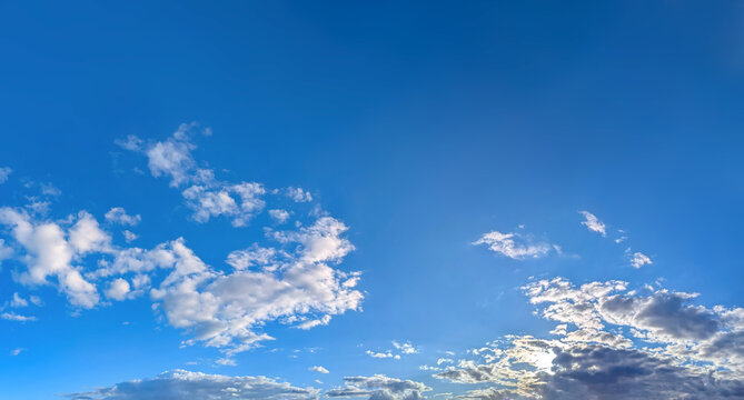 Shadows of sunset clouds. with empty space. Dramatic high-altitude backdrops of gold textured cloud. Panorama volumetric light shadow, glowing deep contemplation. Majestic scenery light.