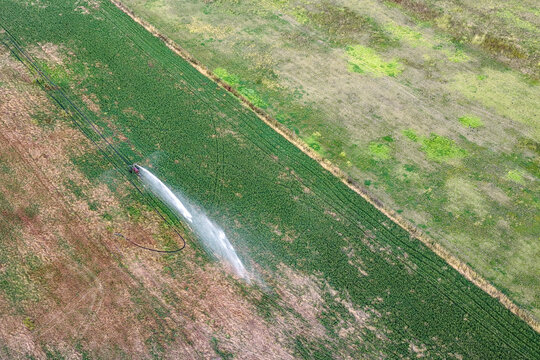Aerial downward view of travelling irrigator watering farmland in New South Wales, Australia. Agricultural landscape showing irrigation system 