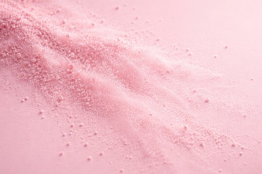 Light pink powder granules spreading in gentle dispersion