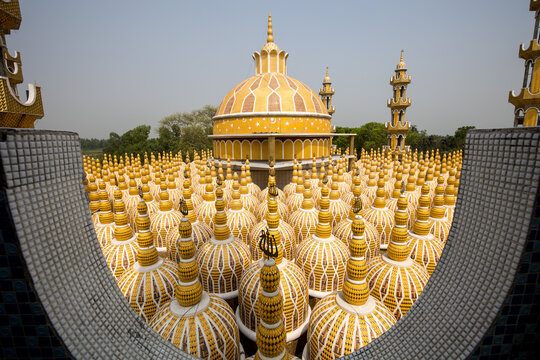 View of a mesmerizing golden domescape, a sea of ornate structures under a hazy sky, creating a stunning visual spectacle, Tangail, Bangladesh.