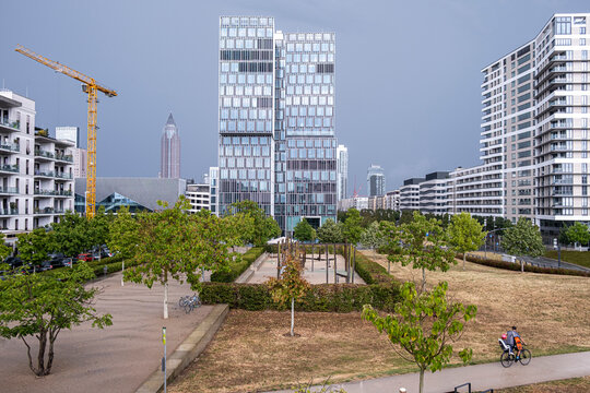 Modern cityscape apartments in Frankfurt near Europagarten Germany with urban park crane and development showing a growing residential district skyline