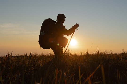 Hiking adventure at sunset scenic field outdoor experience tranquil atmosphere side view exploration