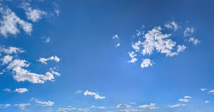 A relaxed clouds decomposing in the wind, spreads into a pancake shape. The lazy, hot structure of the steam. Bright blue sky with some cirrus clouds.