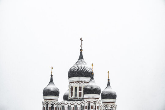 View of the majestic Alexander Nevsky Cathedral rises against the stark white canvas of a winter sky, an architectural marvel in the snow, Tallinn, Estonia.