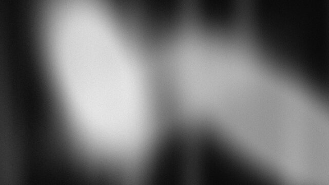 Abstract dark grainy gradient background with soft glowing light