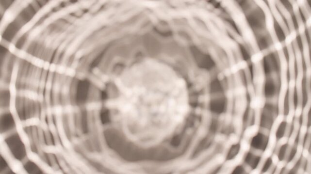 Multiple waves of water cross each other and reflections sunlight in slow motion. Shadow effect. Ripples spontaneously on white background. Beauty shot for skin care cosmetics advertisement. 4k 