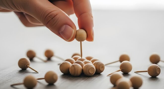 Selecting a leader and human resource management. Strategy planning and unique choice. Hand picking one wooden pin from a group of many on a dark wooden table