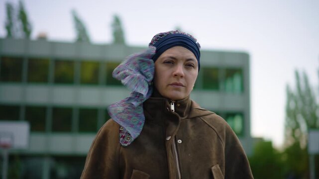 cancer patient standing outdoors observing surroundings during chemotherapy treatment reflecting awareness independence and resilience while coping with illness and recovery journey