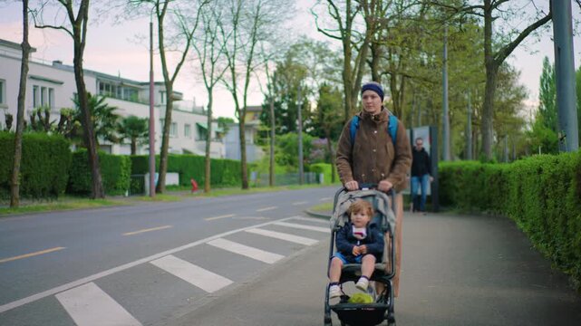 mother with cancer pushing toddler in stroller along urban street during chemotherapy treatment showing daily parenting routine resilience and coping with illness in everyday life