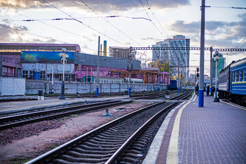 Fototapeta premium railway tracks at the station next to a train on the platform