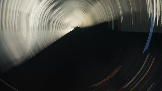 Spinning modern skyscraper creating dizzying abstract light trails